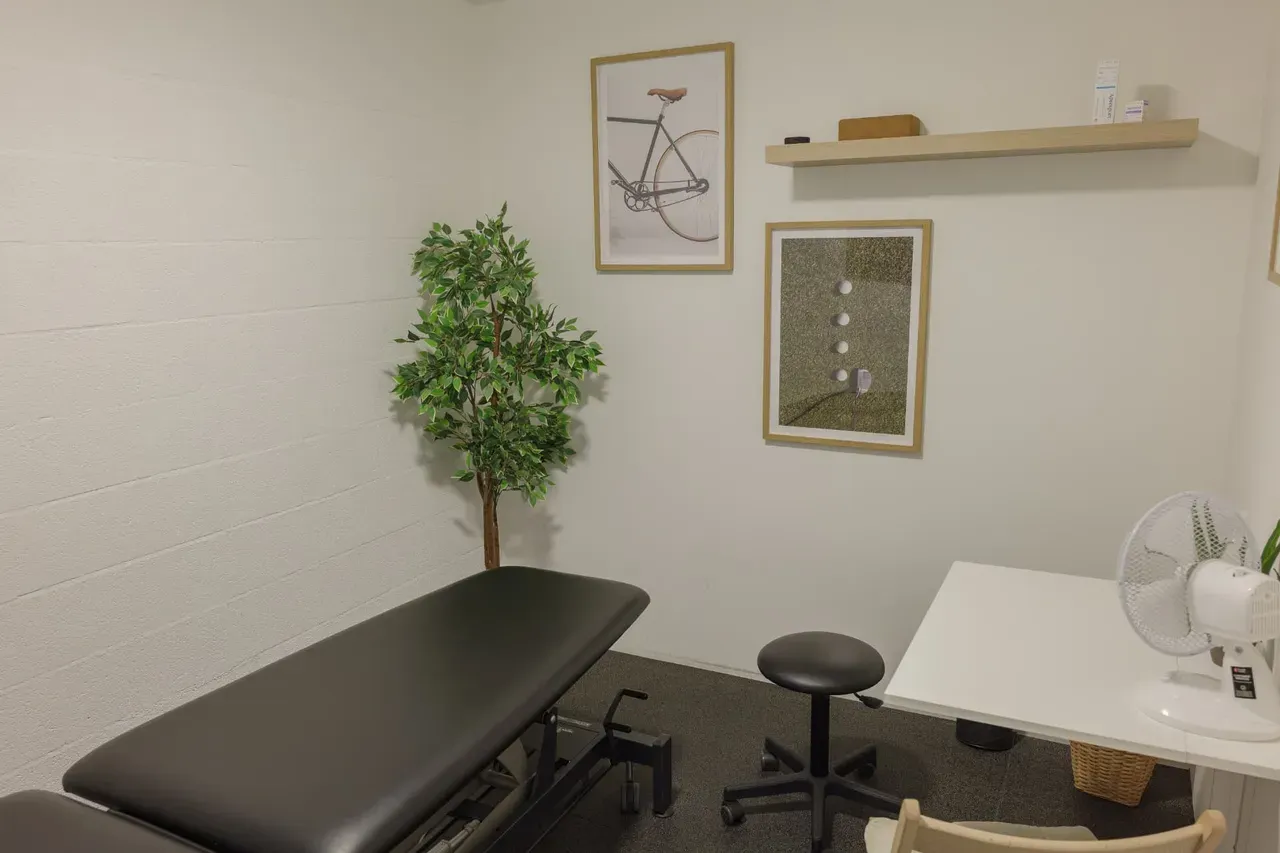 Private Off-Field physiotherapy room with treatment table and assessment desk
